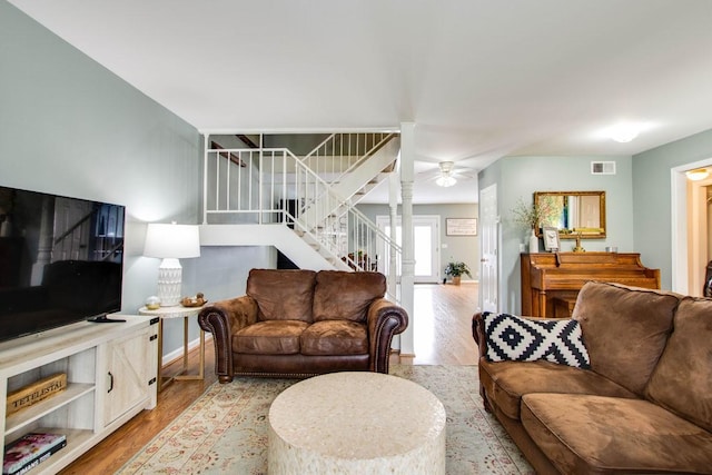 living room featuring ornate columns and light hardwood / wood-style flooring