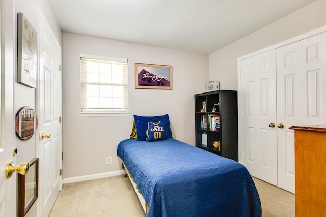 bedroom with light colored carpet and a closet