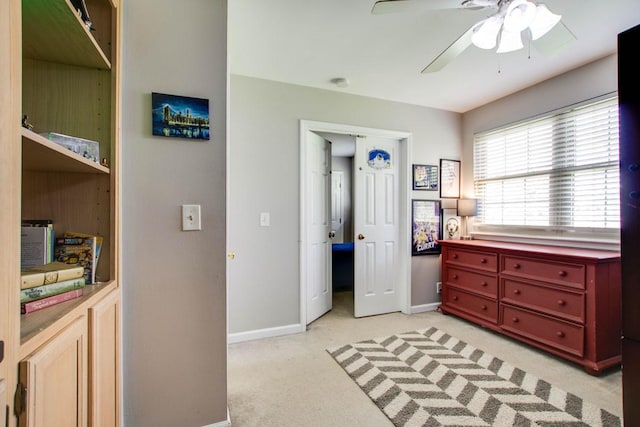 bedroom with ceiling fan and light carpet