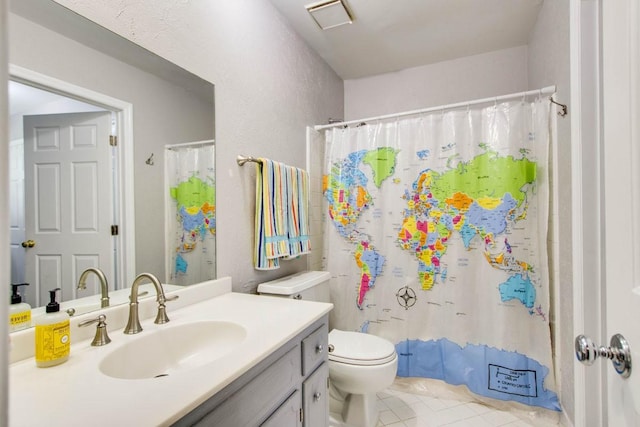 bathroom with vanity, tile patterned flooring, toilet, and a shower with shower curtain