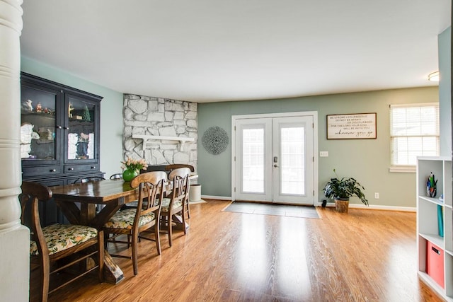 interior space with hardwood / wood-style flooring, a fireplace, and french doors