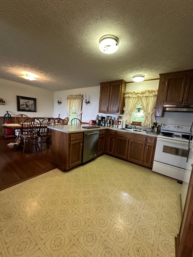 kitchen featuring white electric range, sink, a textured ceiling, stainless steel dishwasher, and kitchen peninsula