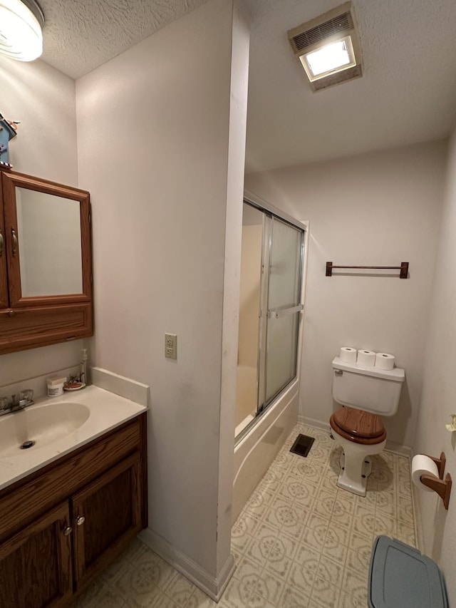 full bathroom with vanity, toilet, enclosed tub / shower combo, and a textured ceiling