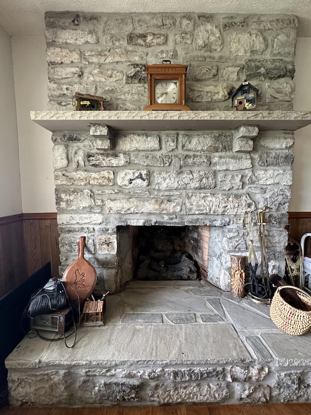 room details with a fireplace and wood walls