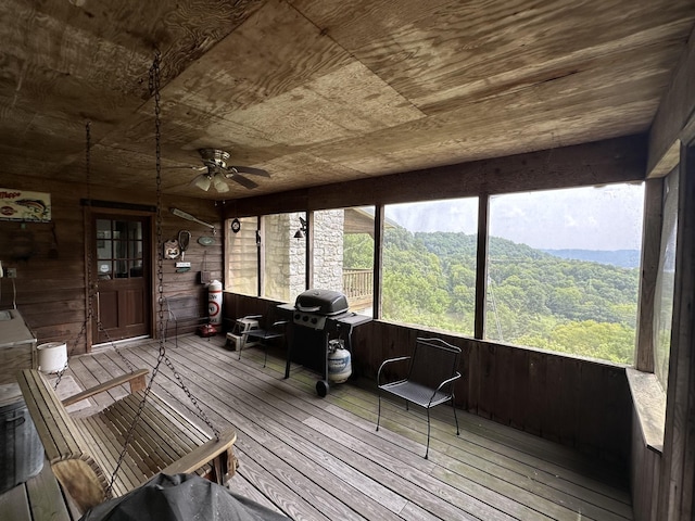 sunroom / solarium with wood ceiling and ceiling fan