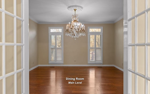 spare room featuring wood-type flooring, plenty of natural light, and ornamental molding