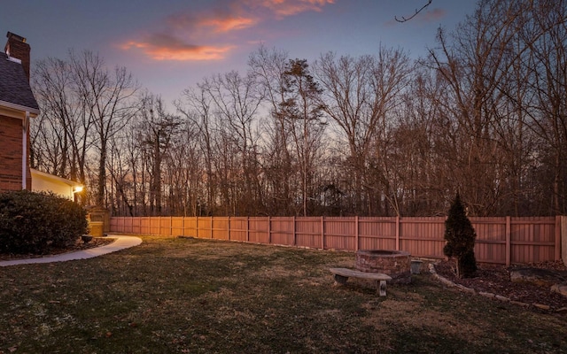 yard at dusk with an outdoor fire pit