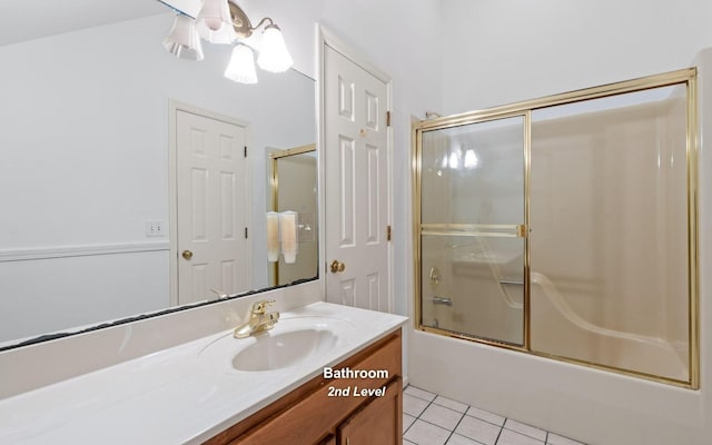 bathroom featuring vanity, combined bath / shower with glass door, and tile patterned floors