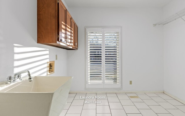 interior space featuring sink, light tile patterned floors, and a healthy amount of sunlight