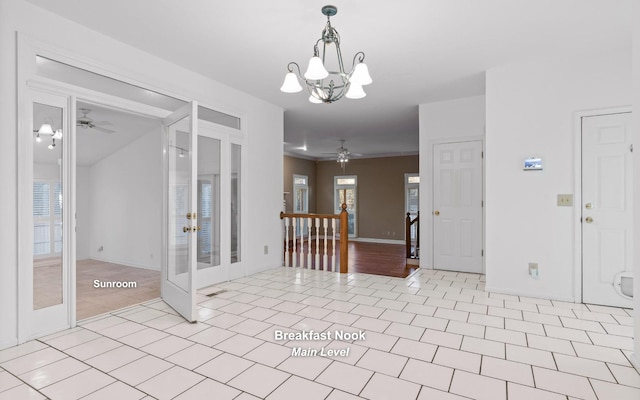 interior space featuring light tile patterned flooring, plenty of natural light, ceiling fan with notable chandelier, and french doors