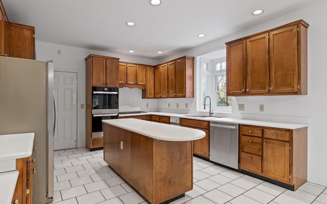 kitchen with appliances with stainless steel finishes, sink, and a kitchen island