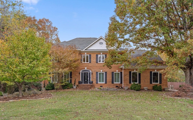 colonial home featuring a front yard