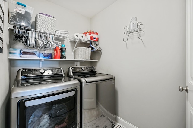 clothes washing area with washer and clothes dryer