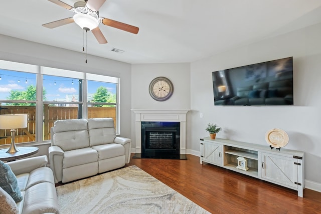 living room featuring wood-type flooring and ceiling fan