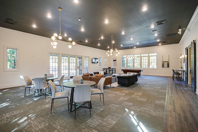 dining room featuring crown molding, french doors, and a chandelier