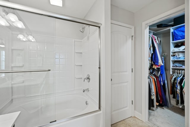 bathroom featuring tile patterned flooring and enclosed tub / shower combo