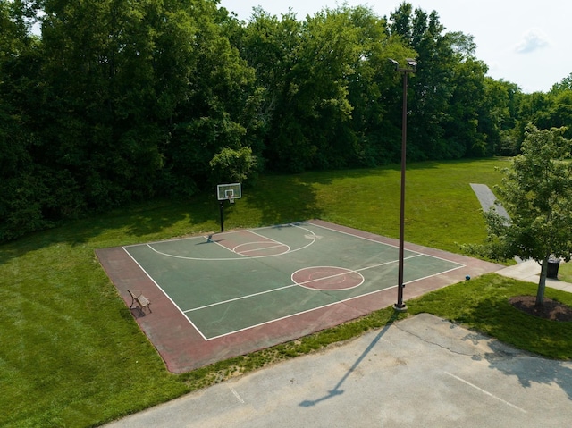 view of basketball court with a lawn