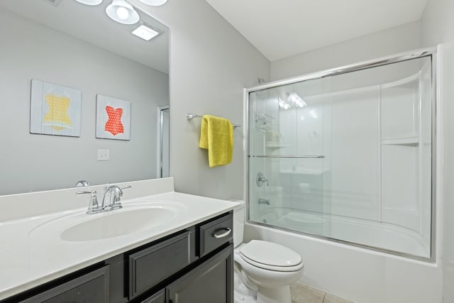 full bathroom featuring tile patterned flooring, enclosed tub / shower combo, vanity, and toilet