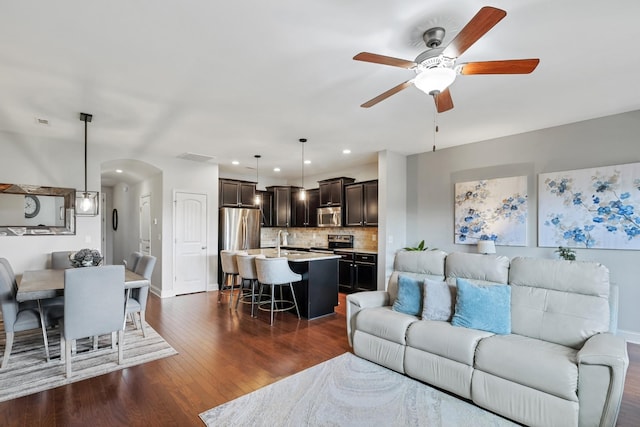 living room featuring dark hardwood / wood-style floors and ceiling fan