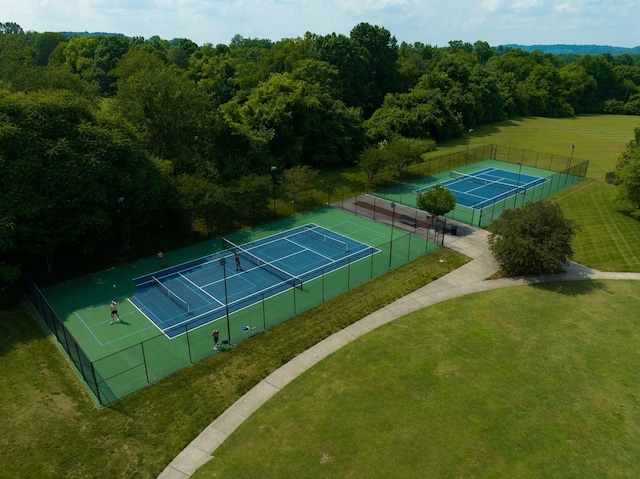 view of sport court featuring a yard