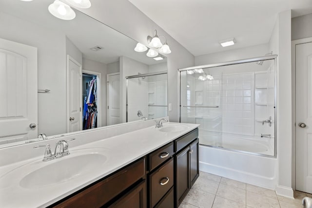 bathroom with tile patterned floors, combined bath / shower with glass door, and vanity