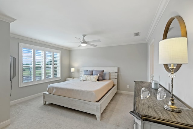 bedroom featuring light carpet, crown molding, and ceiling fan