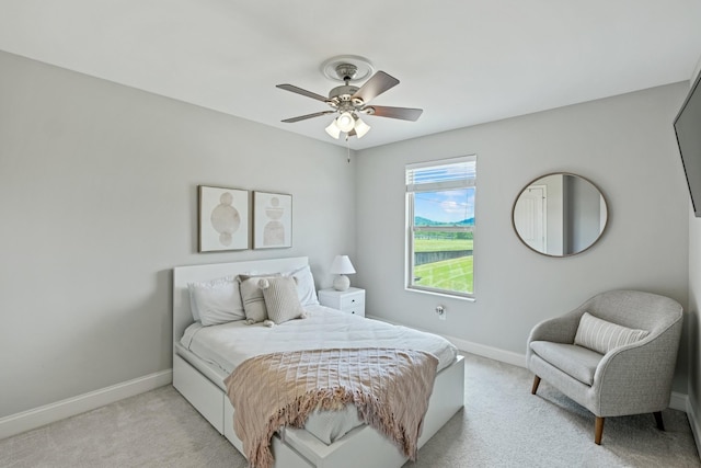 bedroom featuring light carpet and ceiling fan