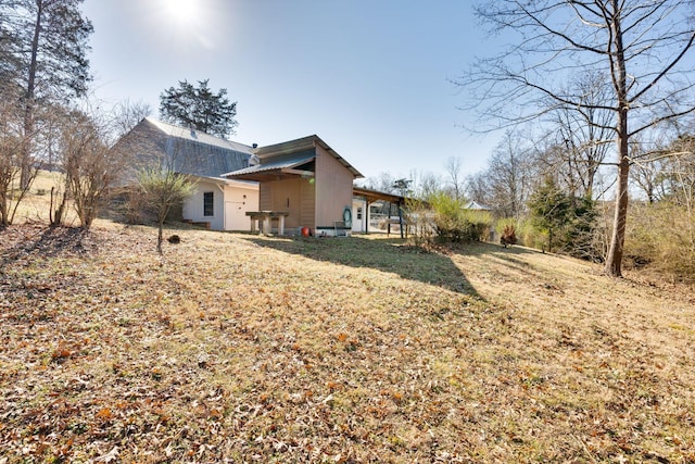 rear view of house featuring a yard