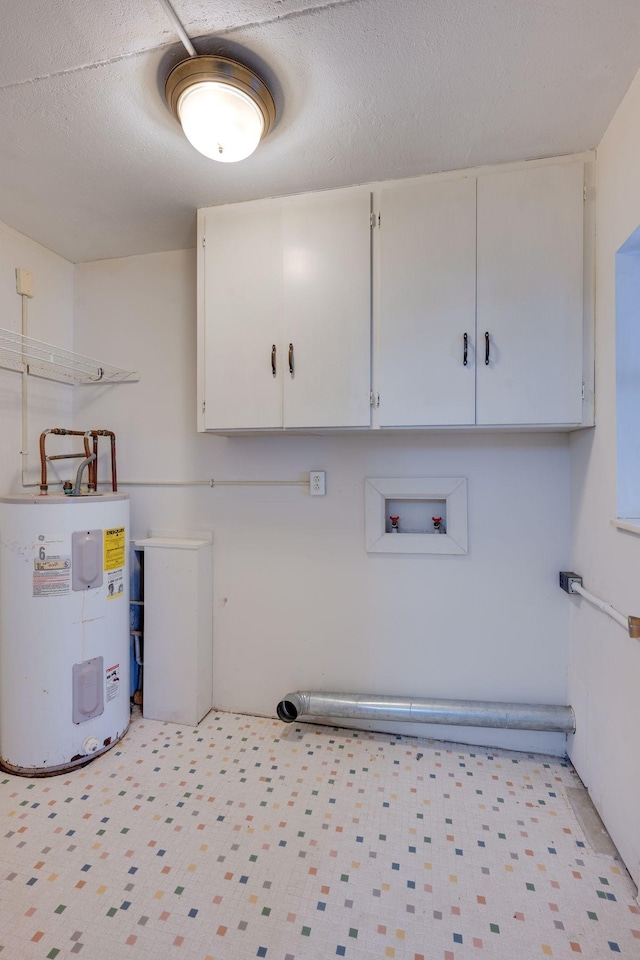 laundry area with hookup for a washing machine, electric water heater, a textured ceiling, and cabinets