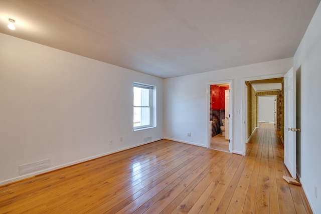 spare room featuring light hardwood / wood-style floors