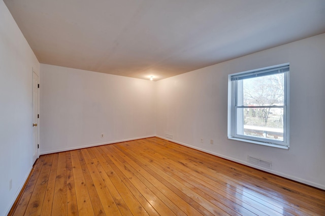 spare room featuring light hardwood / wood-style floors