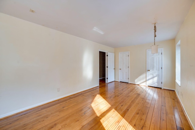 spare room featuring light hardwood / wood-style floors