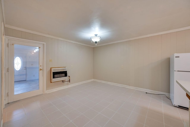 unfurnished living room with crown molding, heating unit, and light tile patterned floors