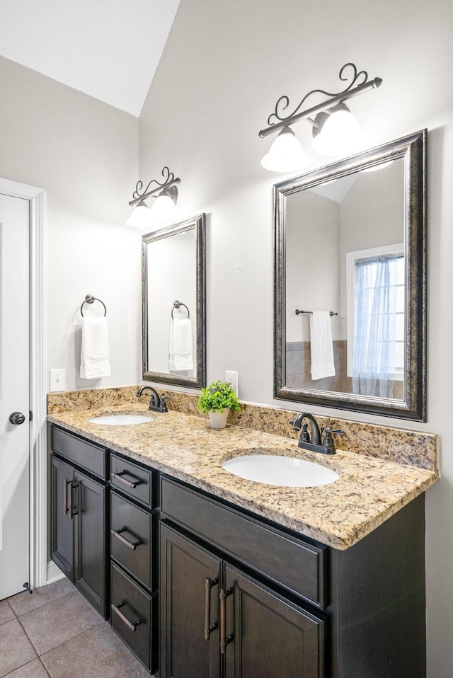 bathroom featuring vanity, lofted ceiling, and tile patterned floors