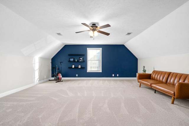 additional living space with lofted ceiling, ceiling fan, a textured ceiling, and carpet