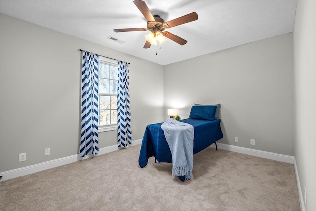 bedroom with light carpet and ceiling fan