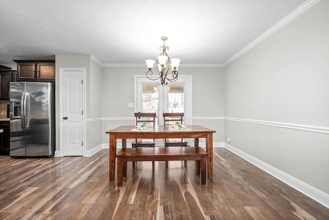 dining area with an inviting chandelier, ornamental molding, and dark hardwood / wood-style floors