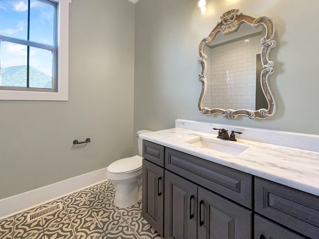 bathroom with vanity, tile patterned floors, and toilet