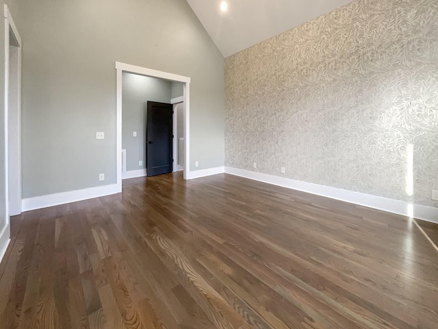 unfurnished bedroom with dark hardwood / wood-style flooring and high vaulted ceiling