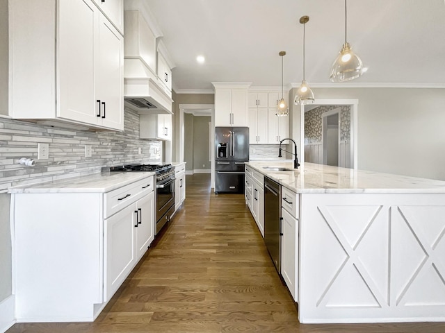 kitchen featuring decorative light fixtures, high quality appliances, white cabinetry, a large island, and light stone counters