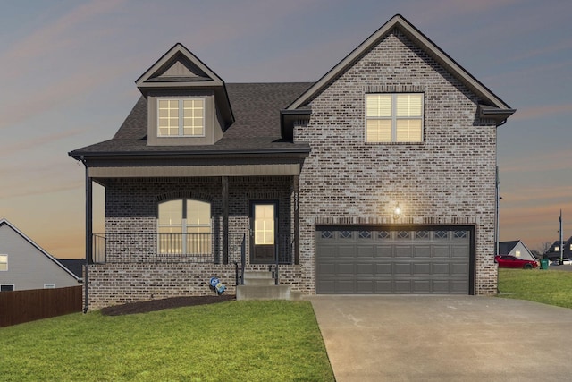 view of front of house featuring a garage and a yard