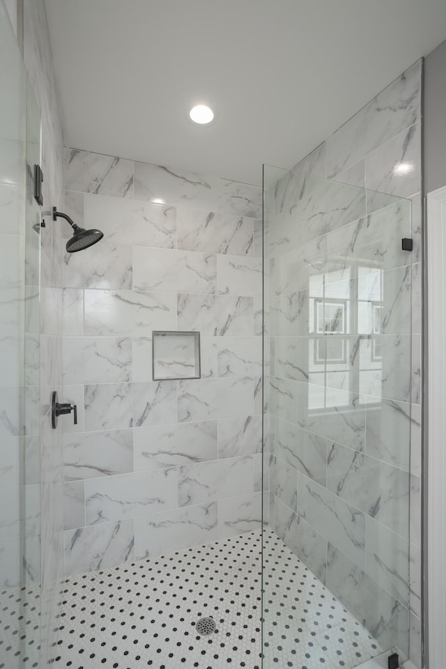 bathroom with a tile shower