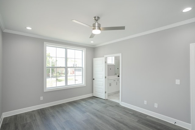 unfurnished bedroom with ornamental molding, dark hardwood / wood-style floors, ceiling fan, and ensuite bath