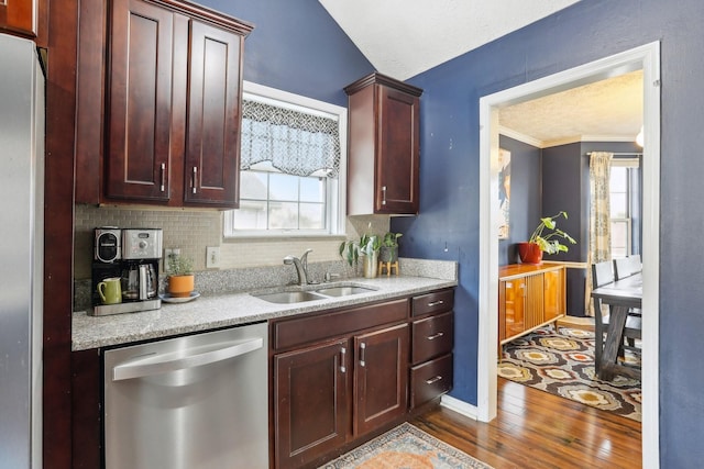 kitchen with stainless steel dishwasher, wood-type flooring, sink, and plenty of natural light