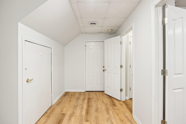 corridor featuring a paneled ceiling and light hardwood / wood-style floors