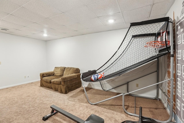 interior space with a paneled ceiling and carpet flooring