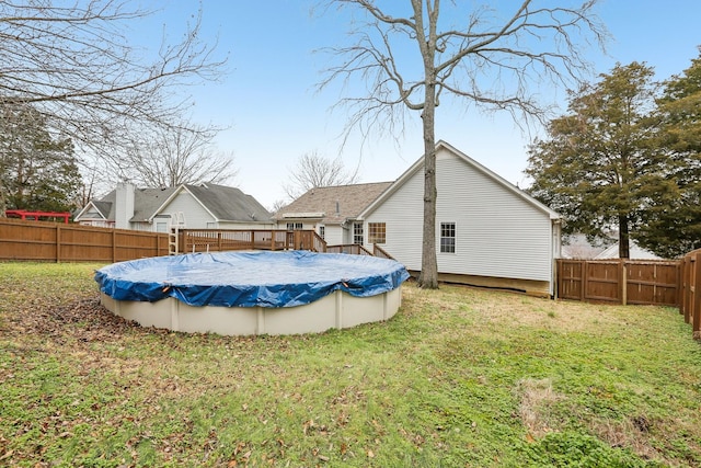 exterior space featuring a covered pool and a yard