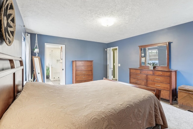 bedroom featuring connected bathroom, carpet, and a textured ceiling