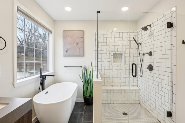 bathroom with vanity and separate shower and tub