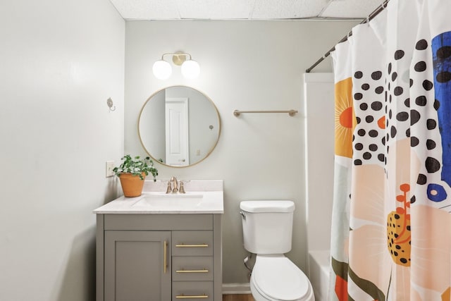 bathroom featuring a paneled ceiling, vanity, and toilet